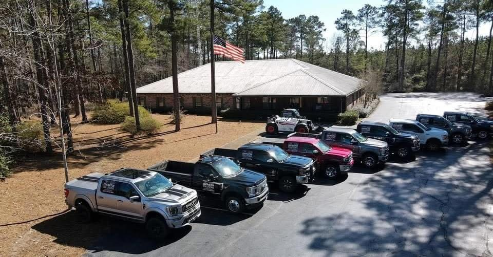 Commercial facility with finished metal roof and fleet staged out front