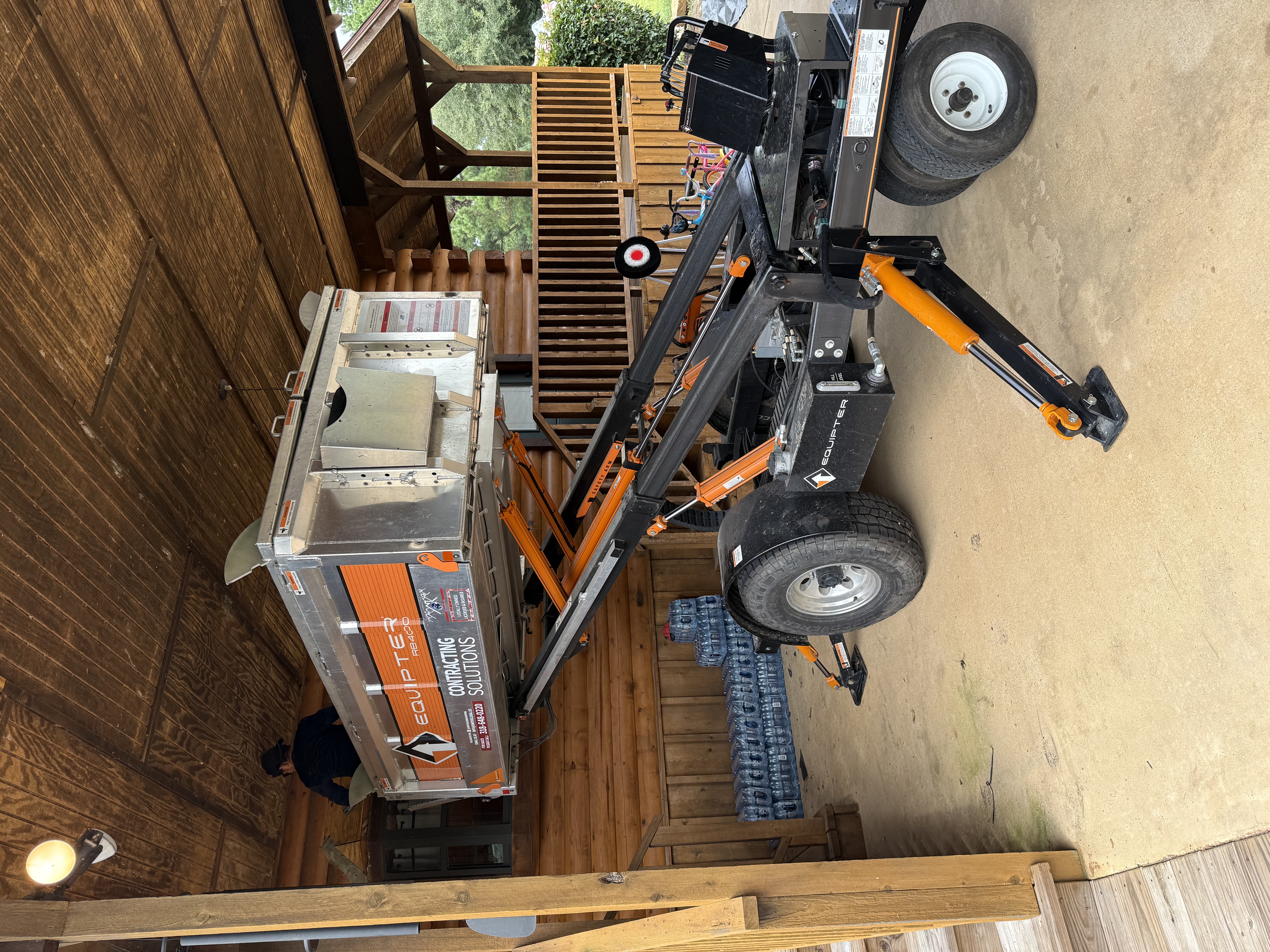 Equipter positioned under the covered patio for tight-access debris removal