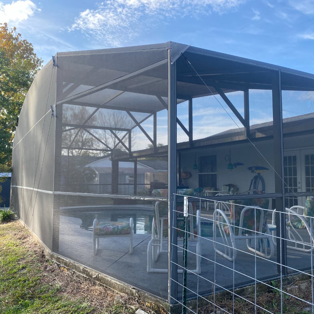 Screen repair inside pool cage — view from pool deck, Deltona FL