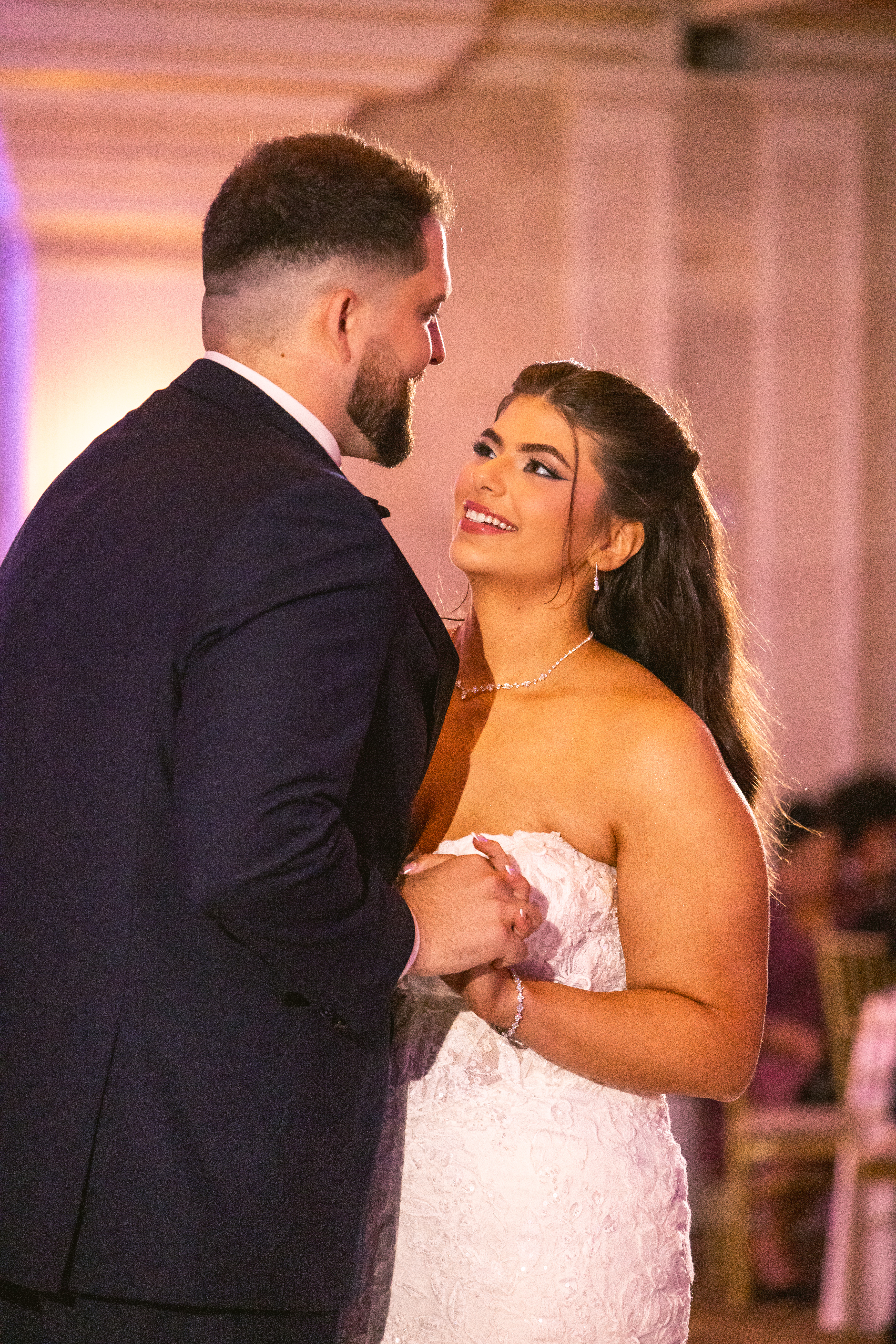 Bride and groom dancing close together at their wedding reception