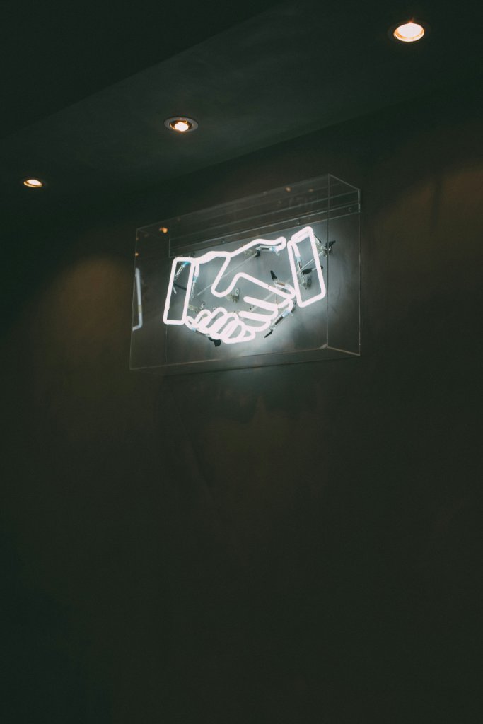 Neon handshake sign