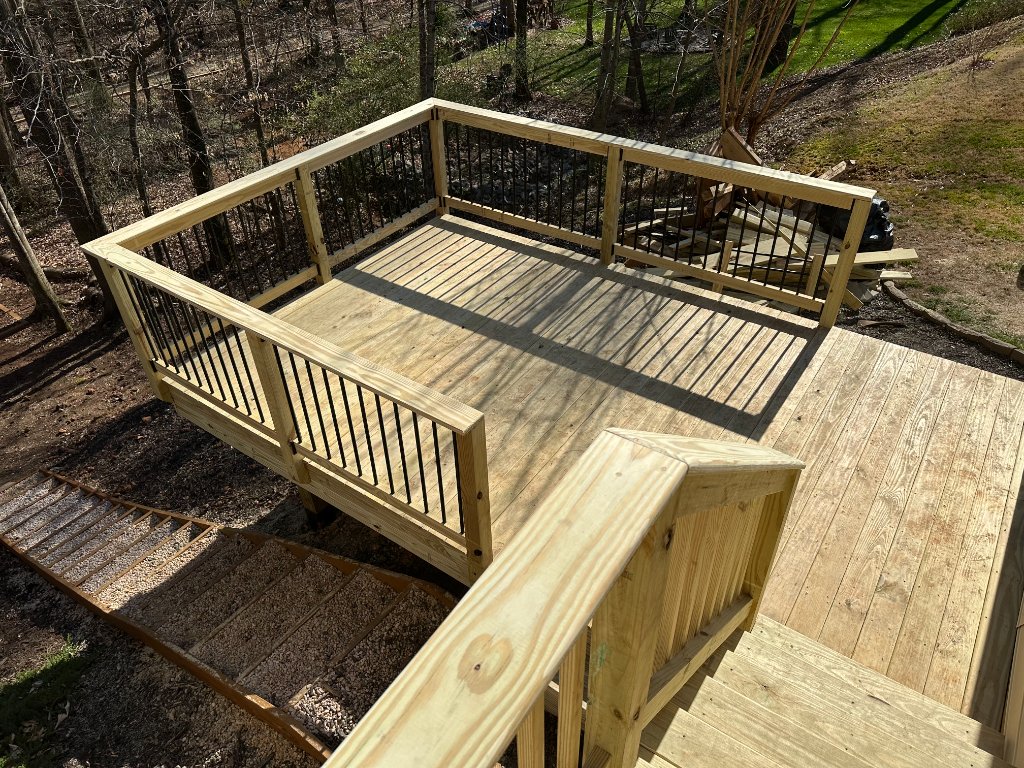 Elevated wood deck with black metal balusters