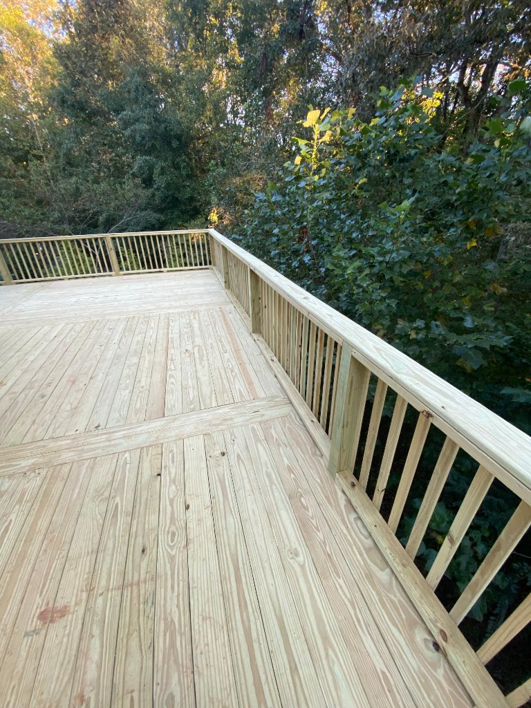 Wrap around wood deck overlooking wooded yard
