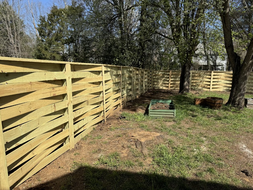 Horizontal slat fence corner with garden beds