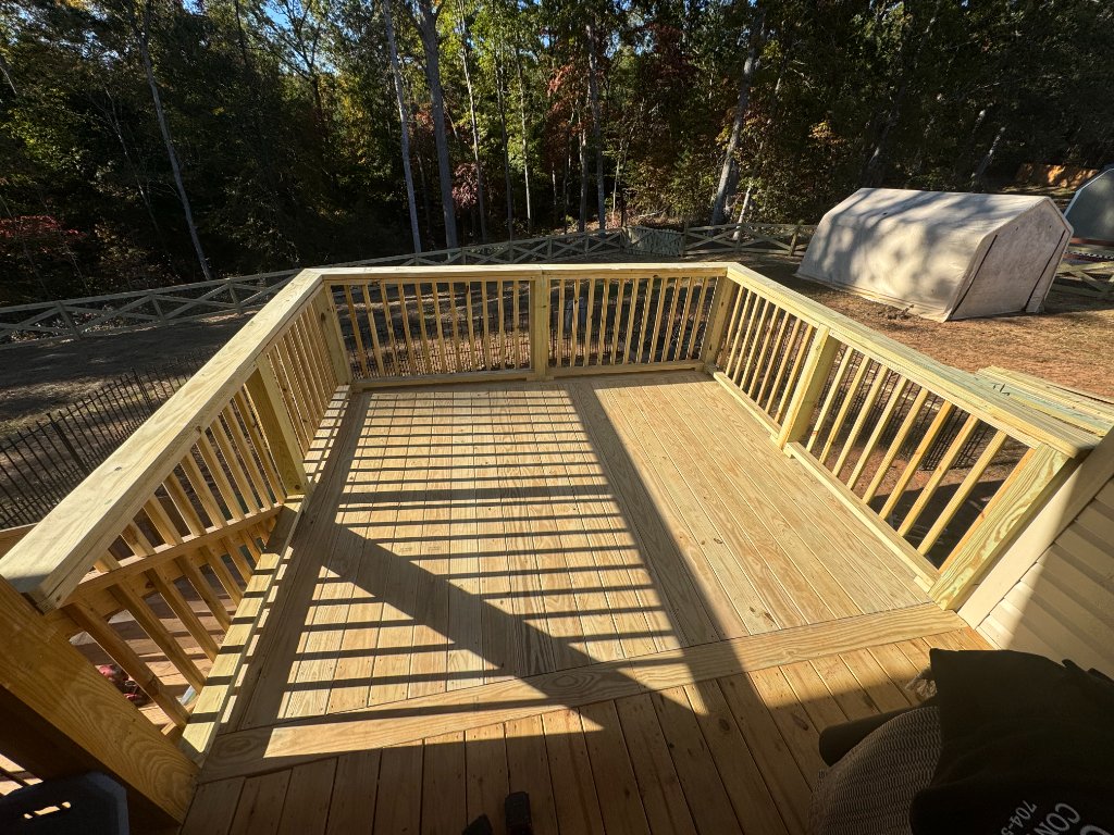 Octagonal wood deck with full railing in autumn