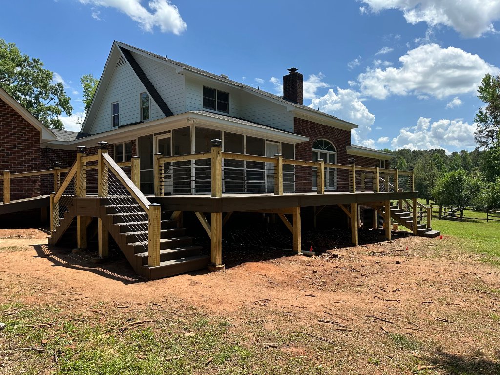 Large composite deck with cable railing and screened porch