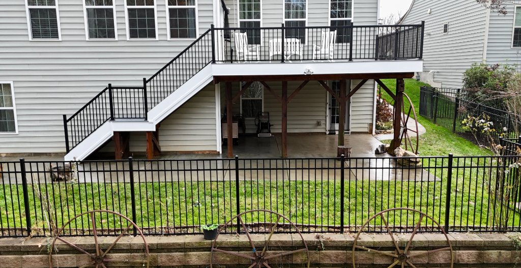 Elevated white composite deck with under-deck patio