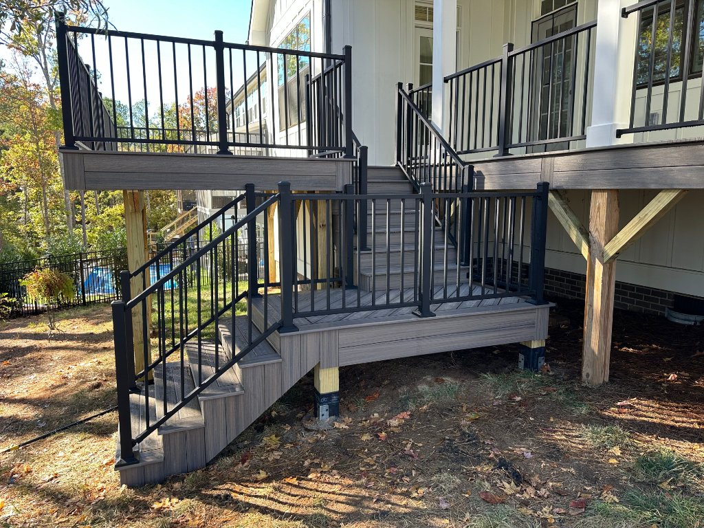 Gray composite multi-level deck with pool view