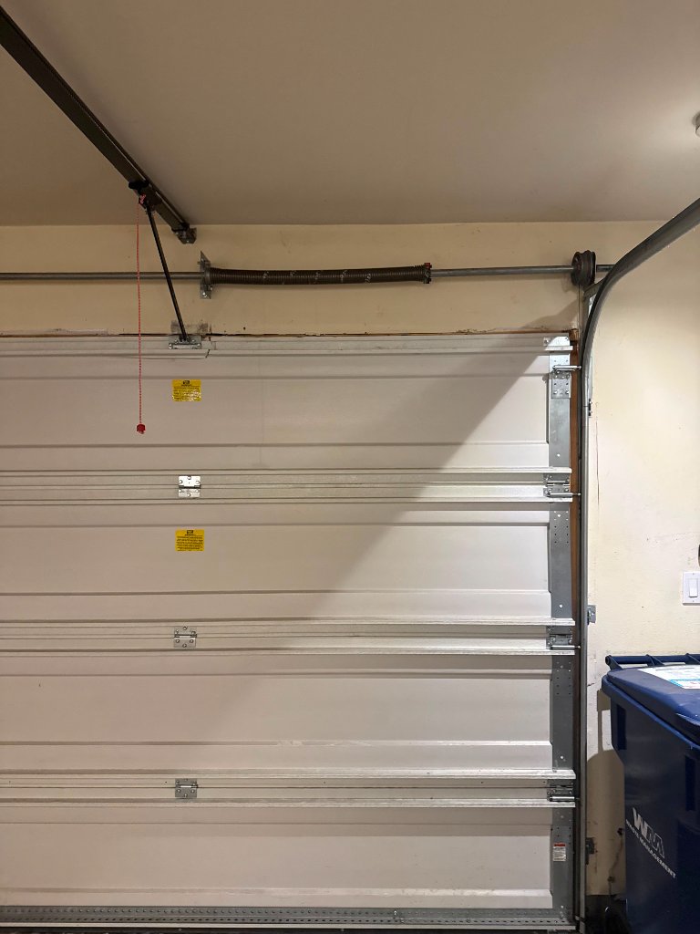 Technician installing a new garage door panel