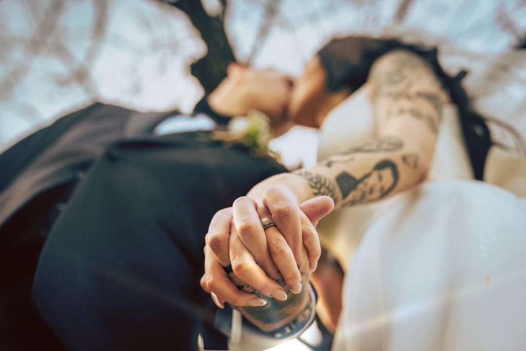 Couple holding hands with rings