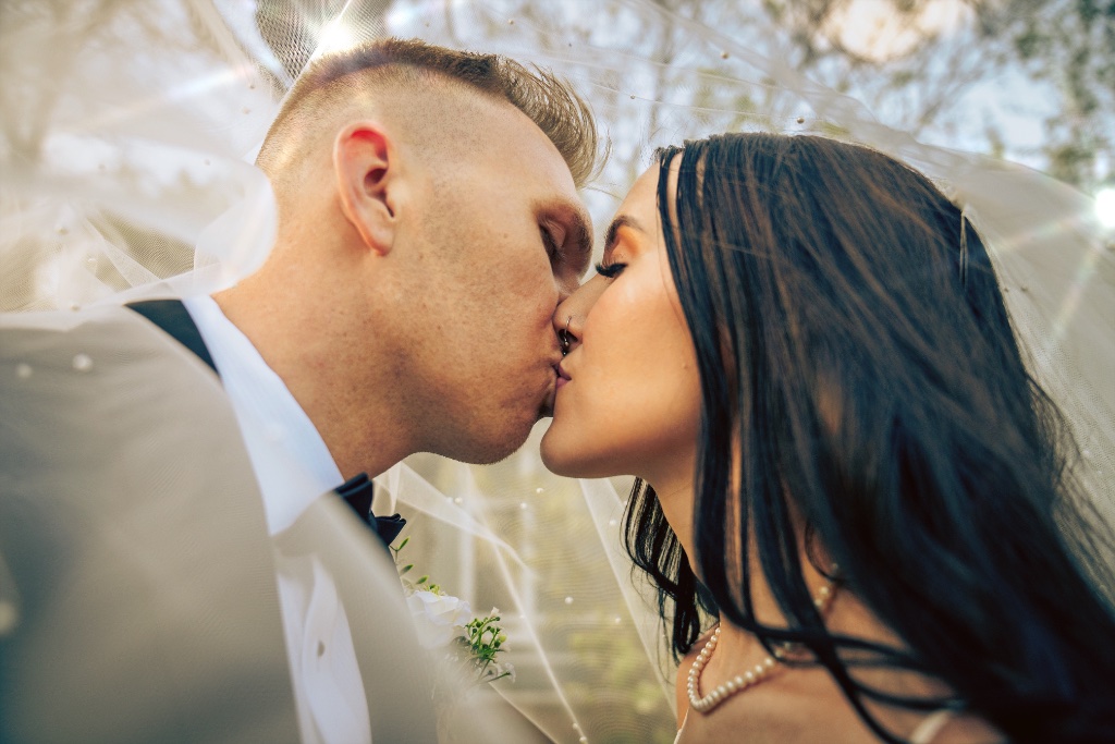 Couple kiss under veil