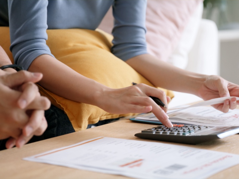 People reviewing fertility finance documents with a calculator