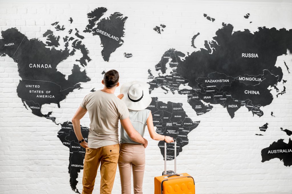 Couple looking at a world map planning fertility treatment abroad