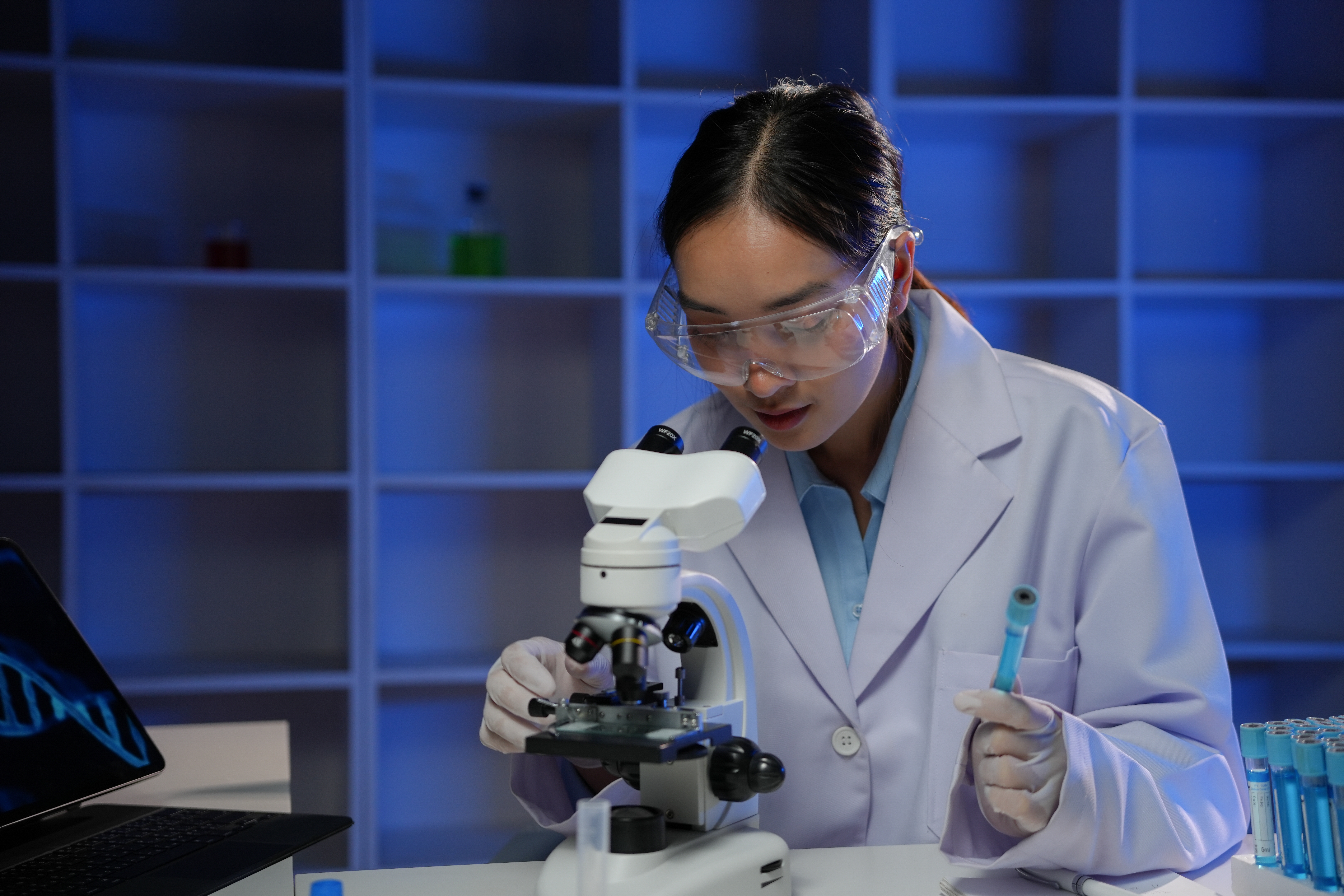 Scientist examining a DNA sample — representing genetic testing costs in fertility care