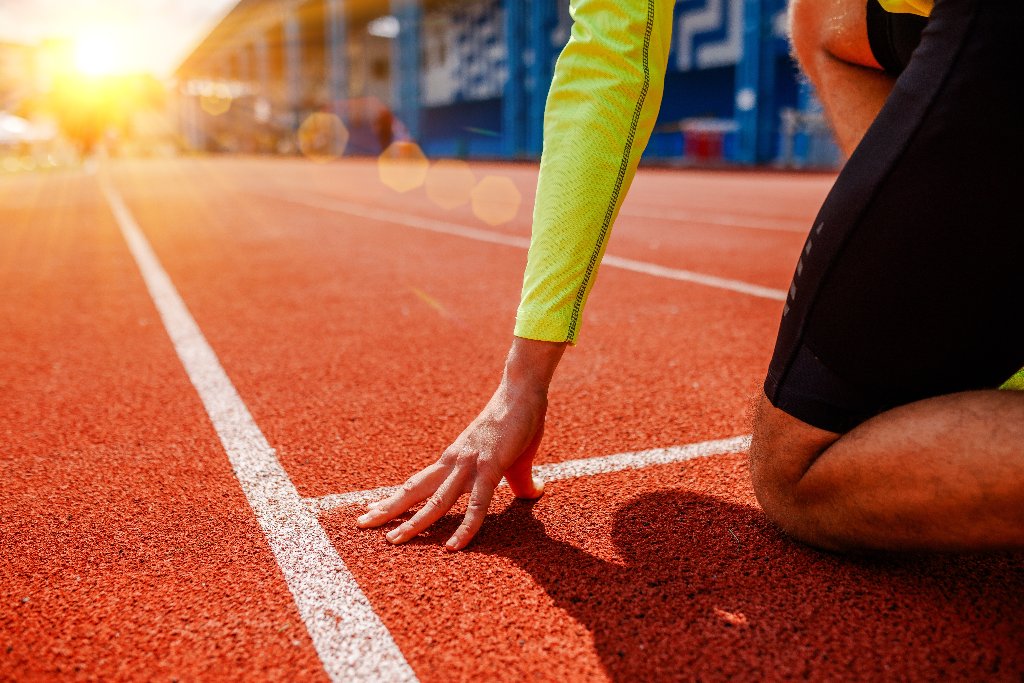 Runner at a starting line on a track, symbolising the start of a fertility journey