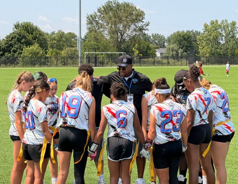 NISOW Elite team huddle with coach on the field