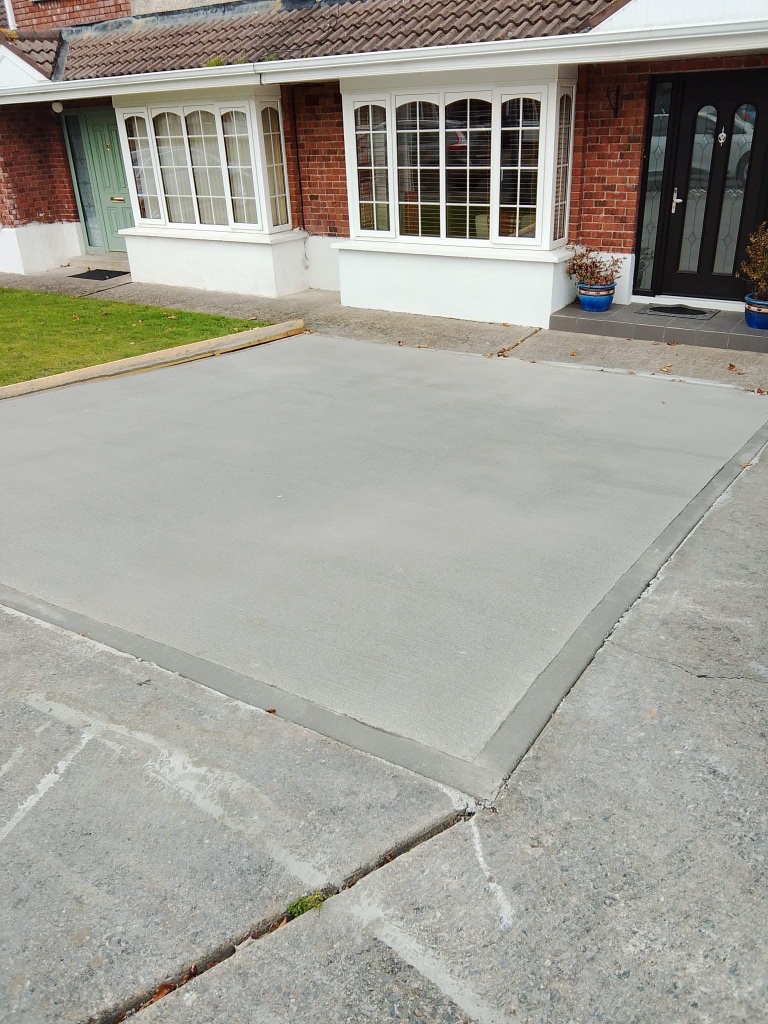 After driveway — new smooth concrete driveway with kerbing