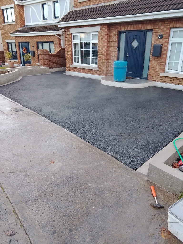 After driveway installation — new tarmac driveway with concrete kerbing