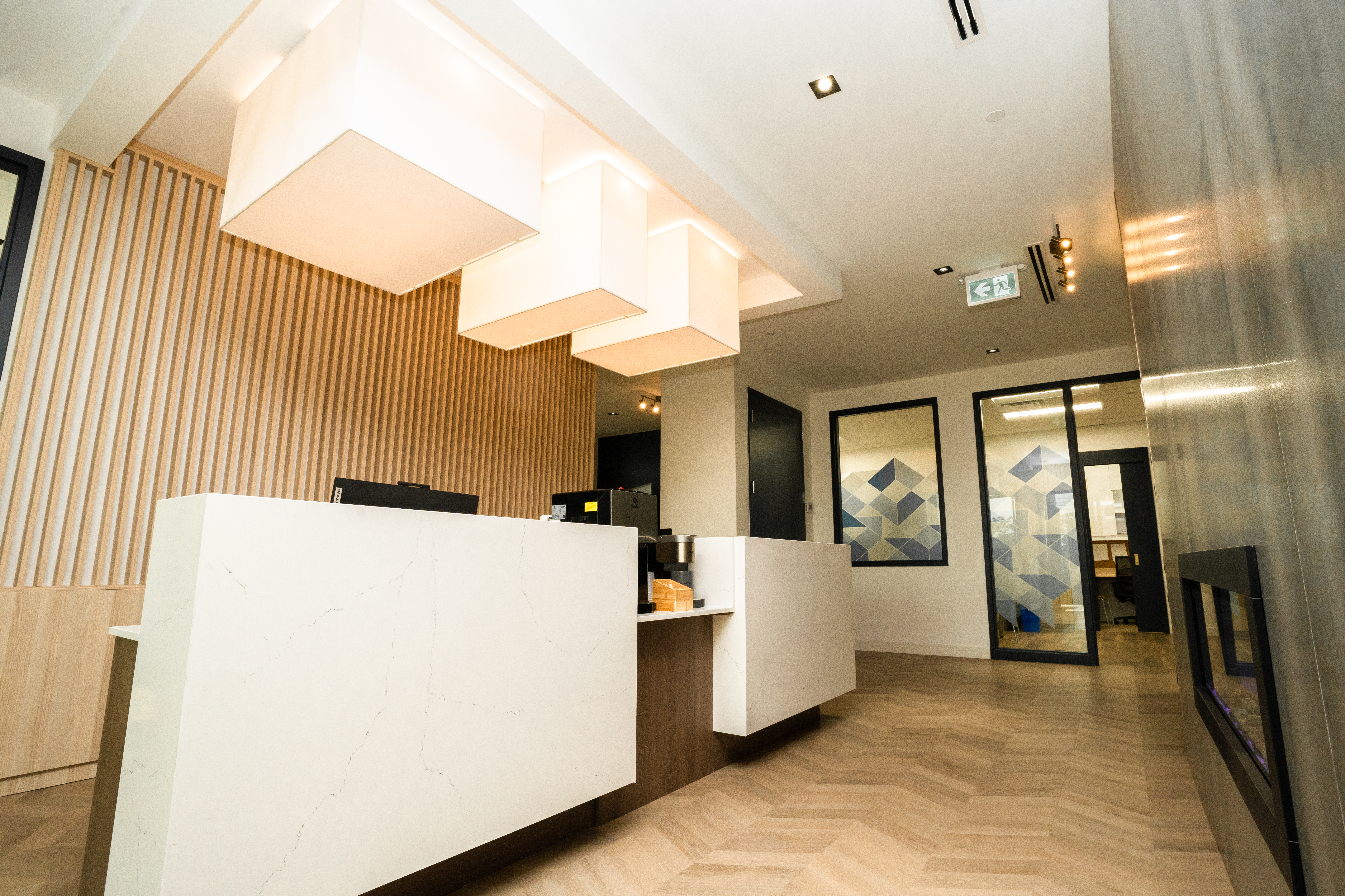 DS Dental reception desk with wood slat feature wall and fireplace