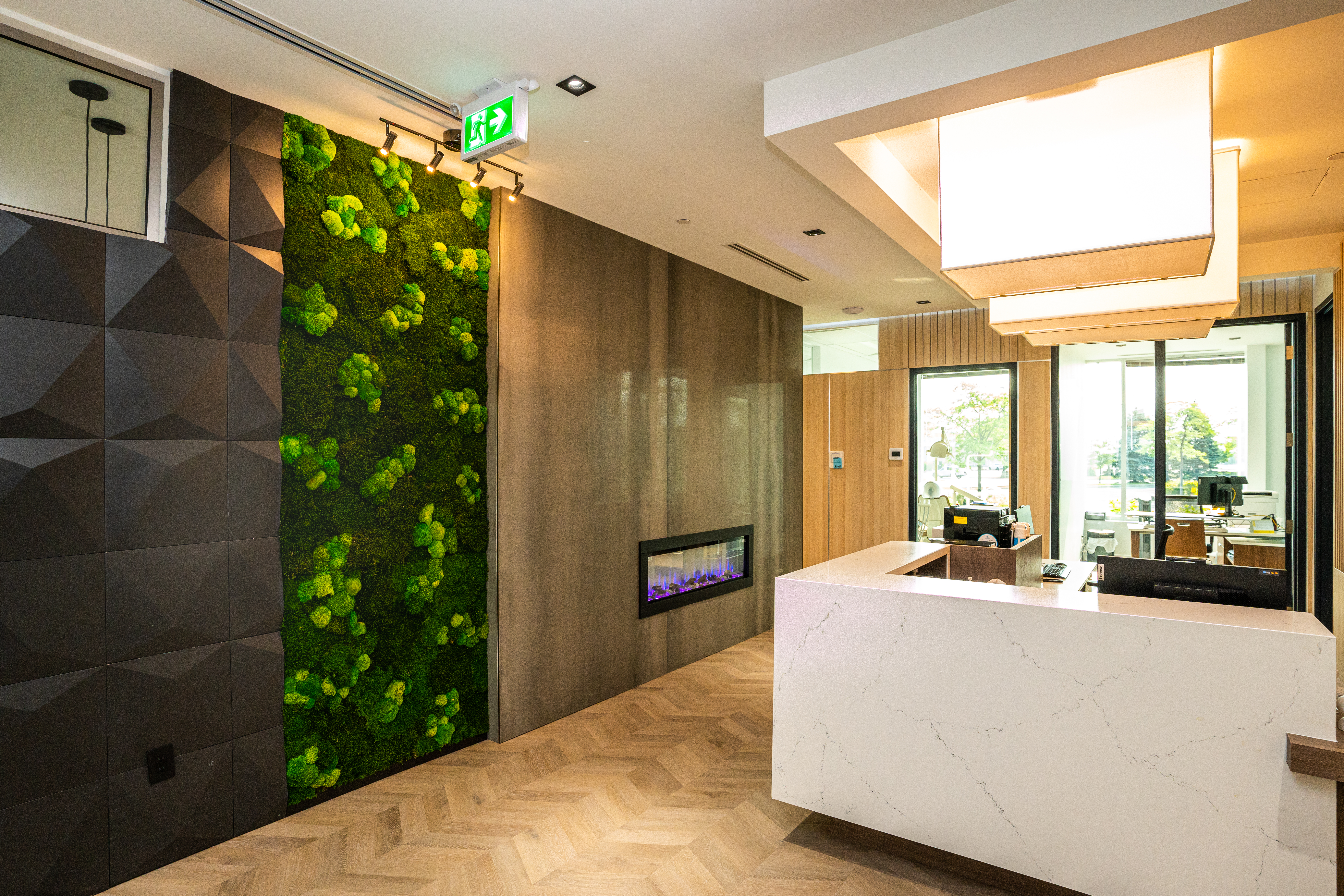DS Dental reception lobby with moss wall and linear fireplace