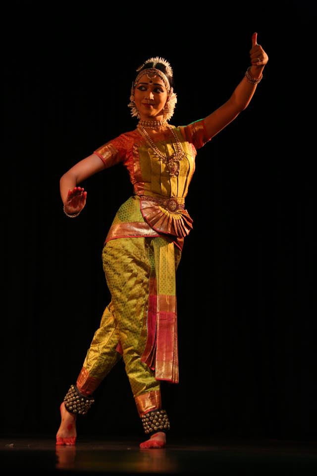 Bharathanatyam dancer in full traditional costume performing on stage