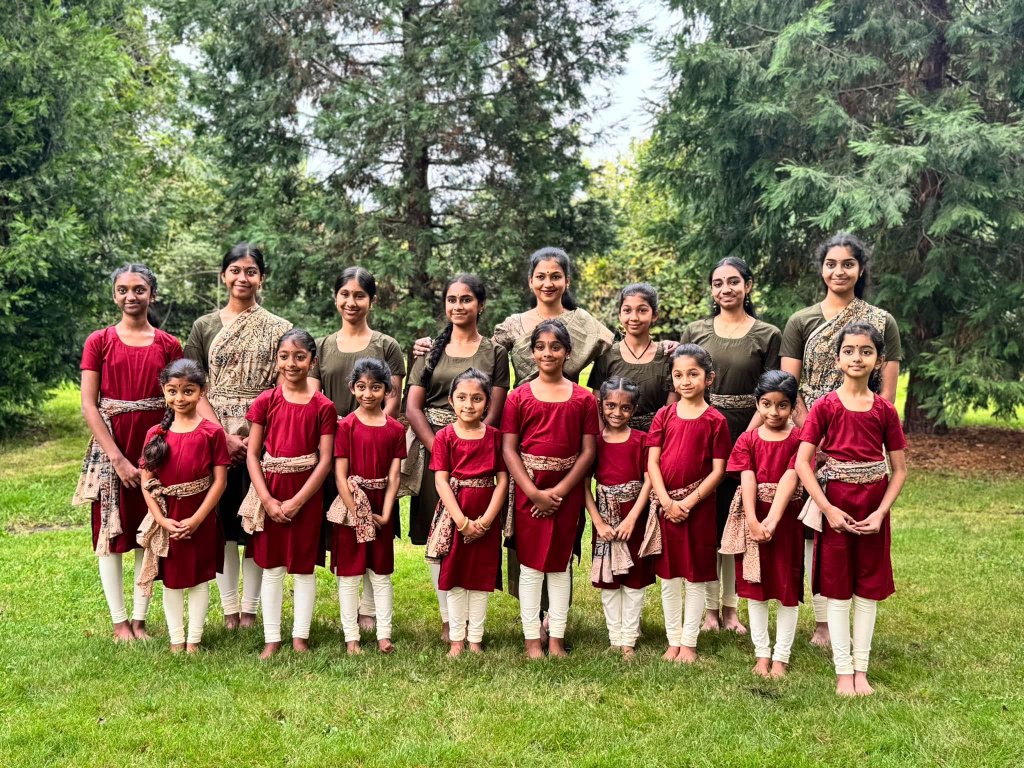 Group of young Bharathanatyam students practicing in unison