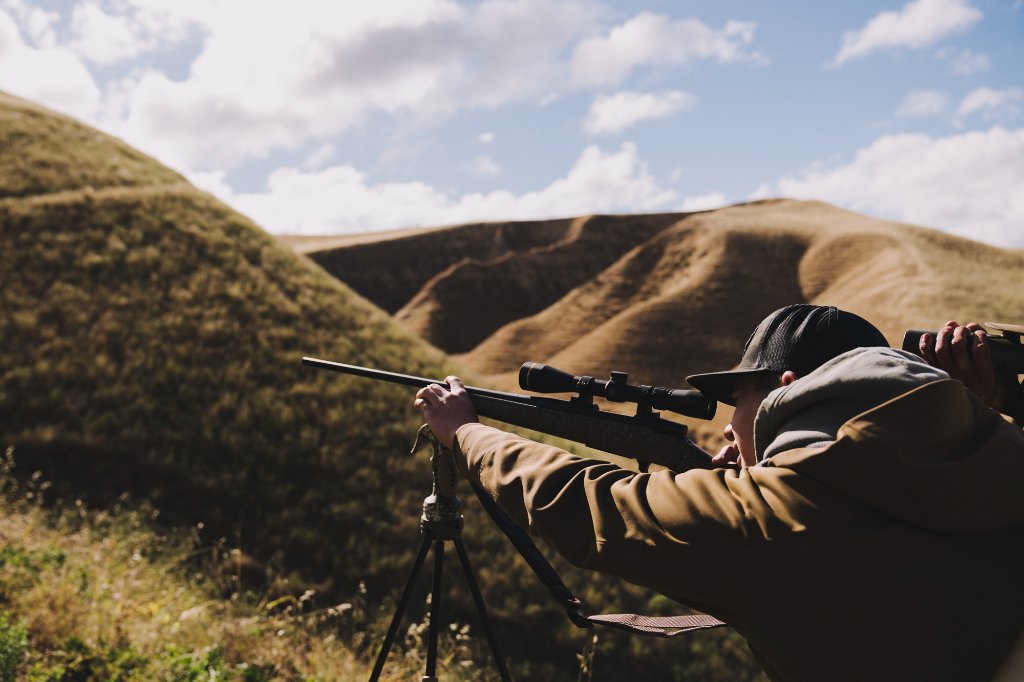 Hunter zeroing a rifle at Camatta Ranch's 13-bay shooting range before a guided hunt