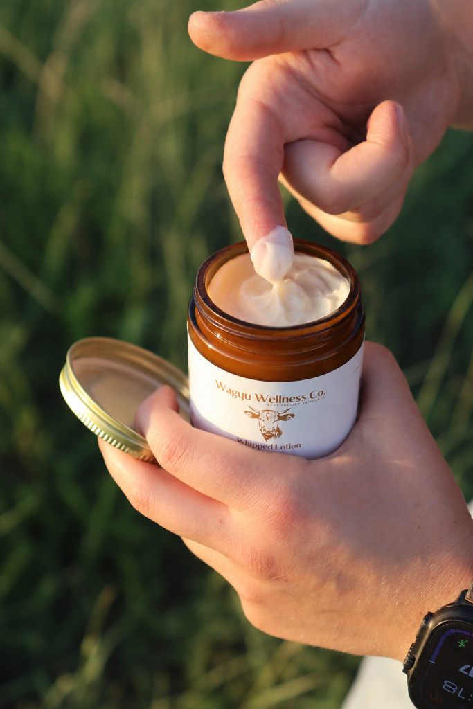 Wagyu Wellness Co. Whipped Lotion held outdoors at golden hour