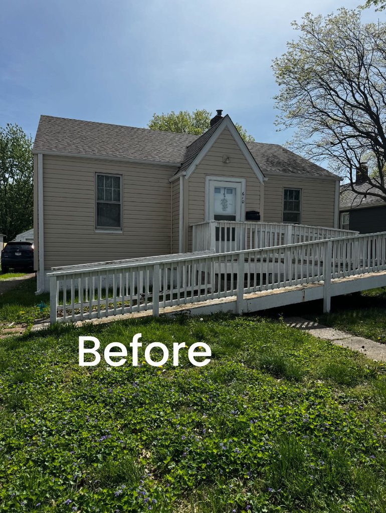 Damaged home with worn roof and deteriorating exterior