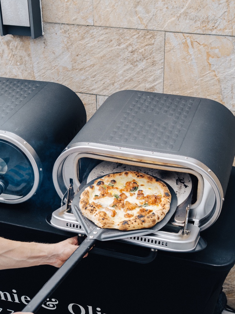 Pizza being pulled from the oven