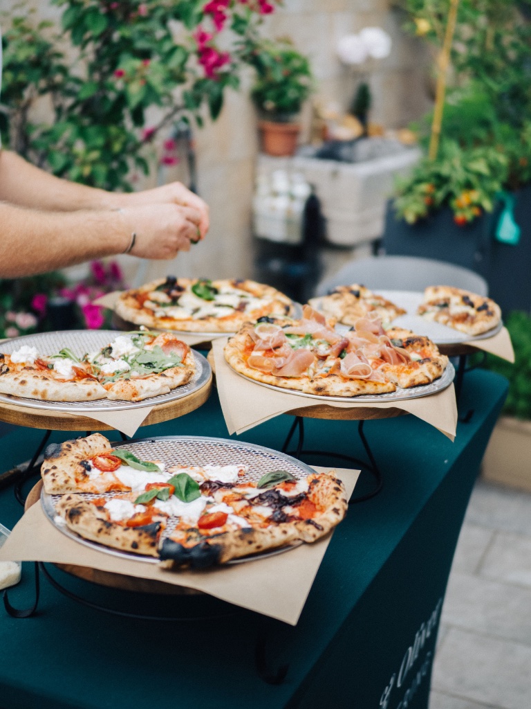 Multiple pizzas served at an event