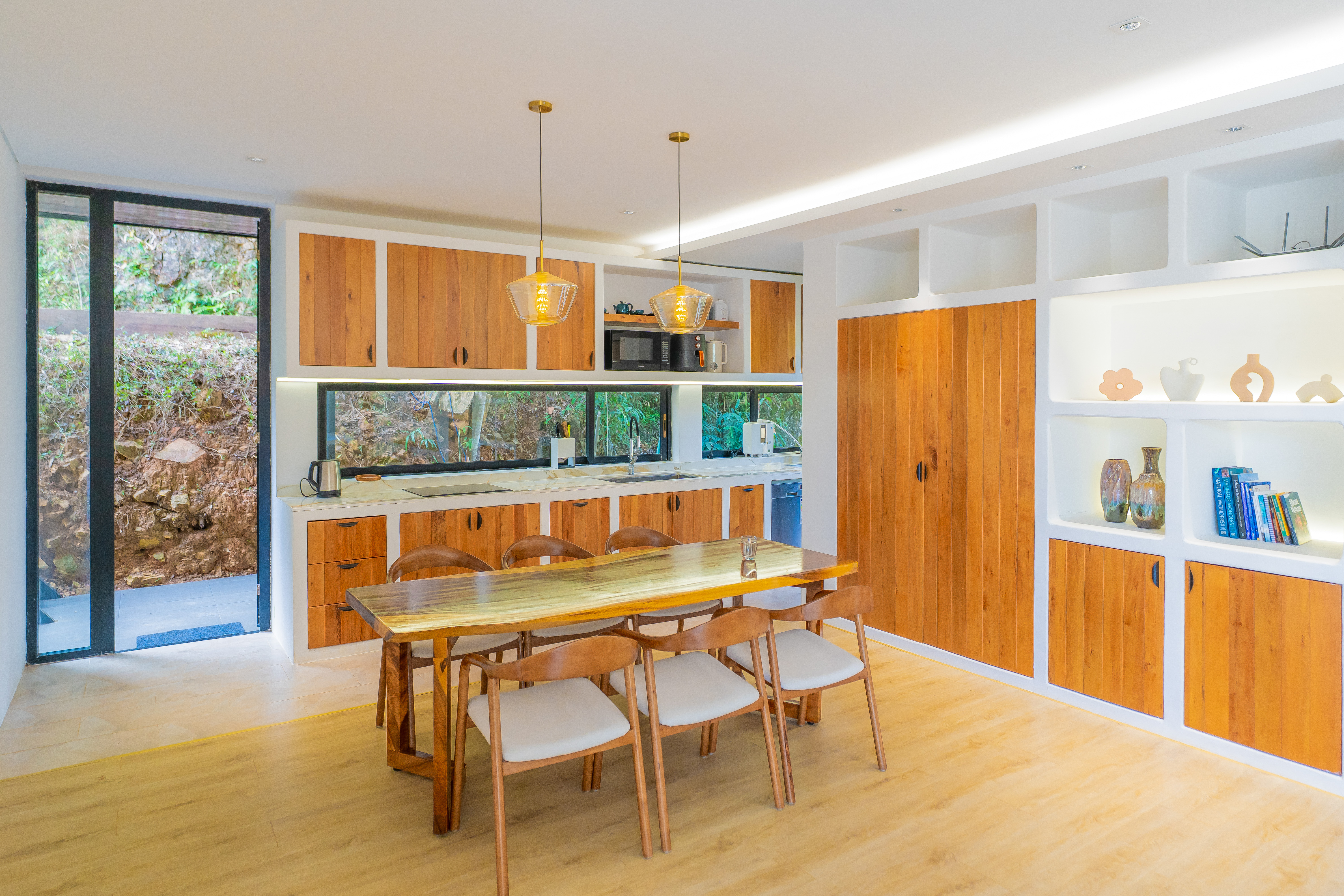 Casa Gaia — open kitchen and dining with live-edge wood table