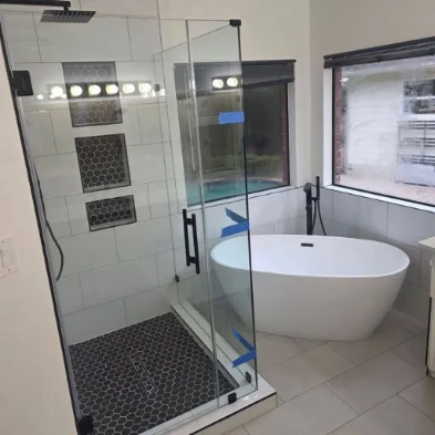 Custom bathroom remodel with large marble tile walk-in shower, black pivot door hardware, hexagon mosaic floor and grey vanity in DFW