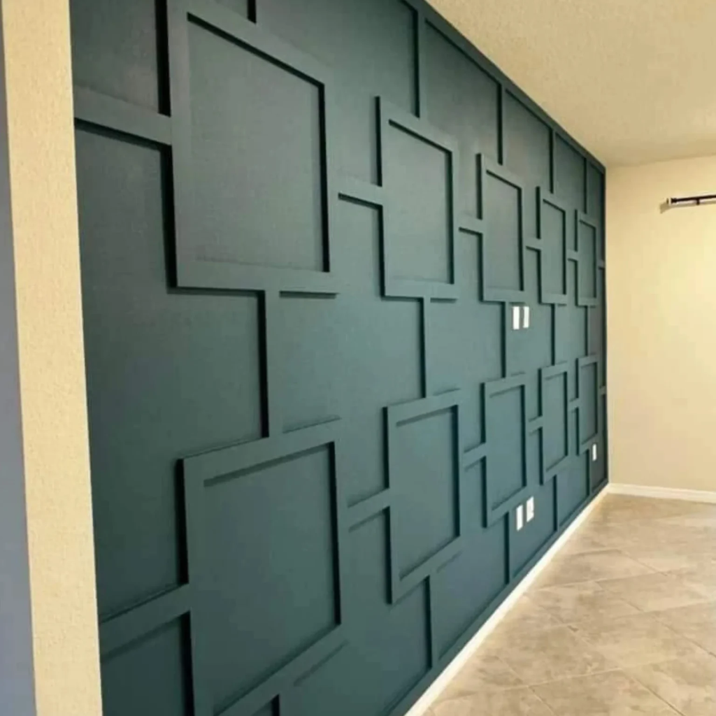 Deep teal accent wall with modern geometric paneling in a living space by 448 Developments Dallas TX