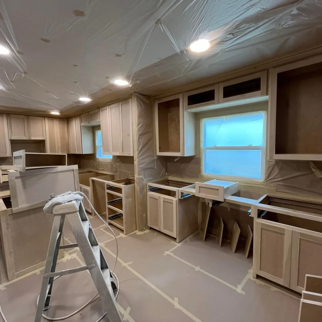 Kitchen remodel in progress showing custom cabinet installation with recessed lighting and new layout in a Dallas home