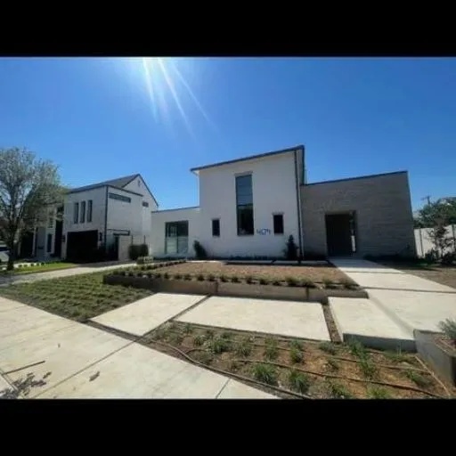 Expansive concrete driveway and sleek front walkway leading to a newly constructed modern home, showcasing high-quality residential concrete solutions across Dallas-Fort Worth.