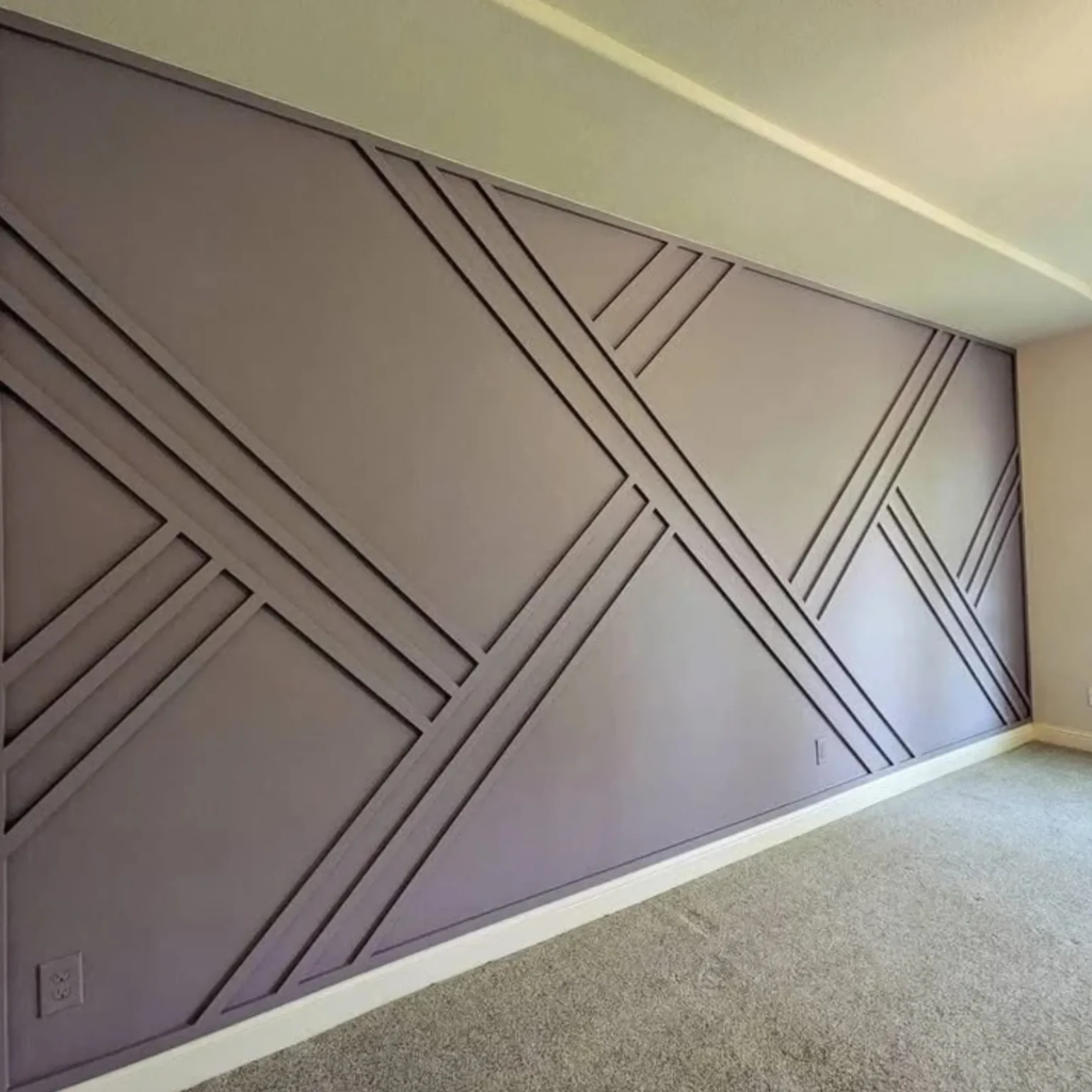 Bedroom accent wall painted in muted gray with subtle geometric molding patterns by 448 Developments DFW