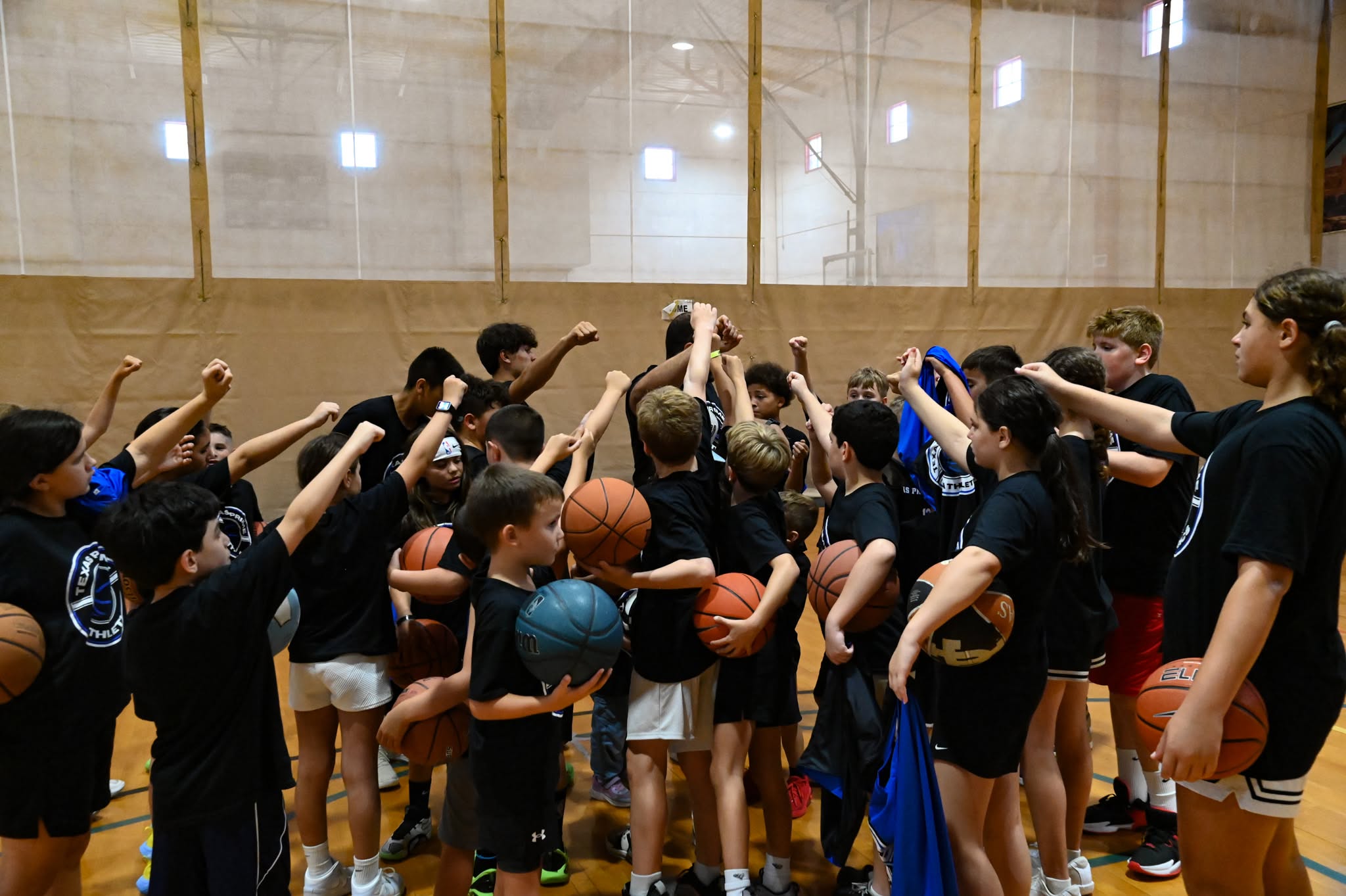 Texas Prime Athletics youth basketball team huddled together