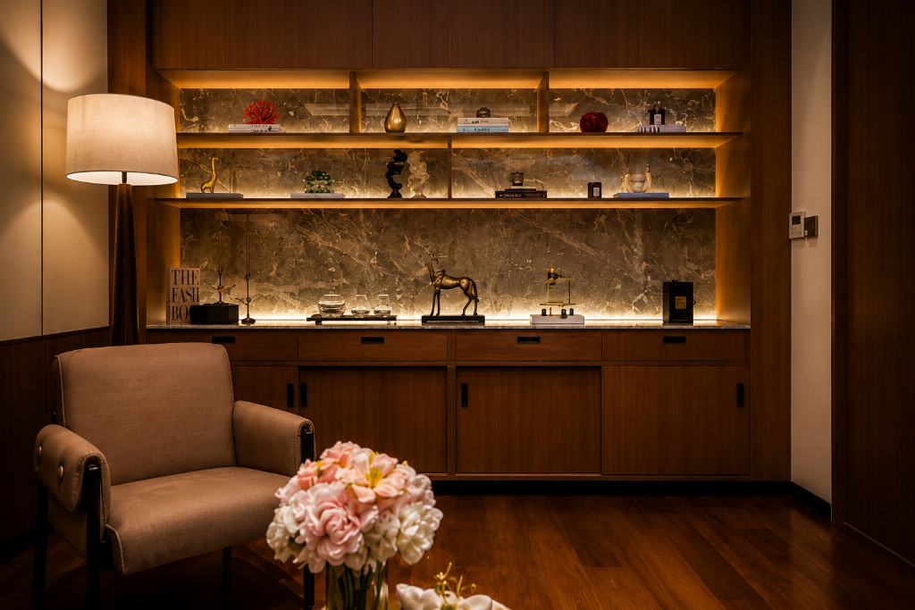 Warmly lit med spa shelving display with lounge chair and pink flowers