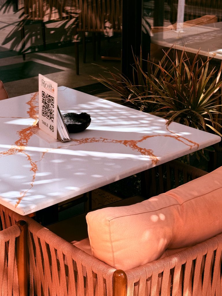 Diner scanning a QR code menu at a restaurant table