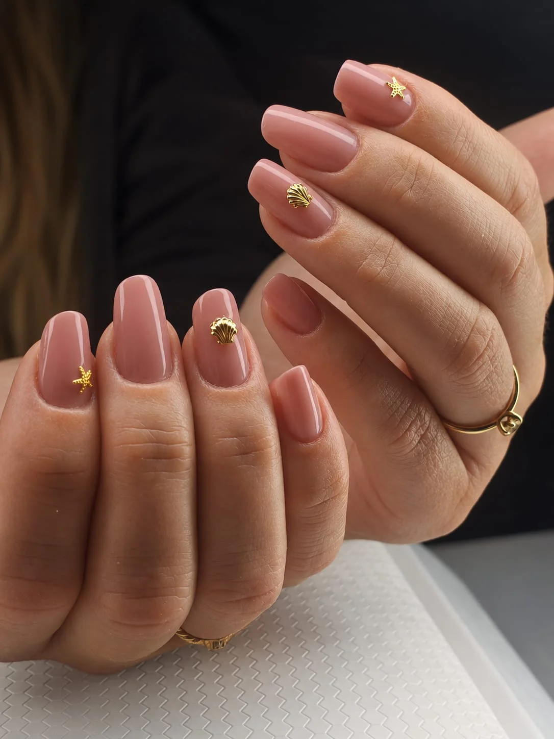 Rosé nails with gold shell and starfish charms