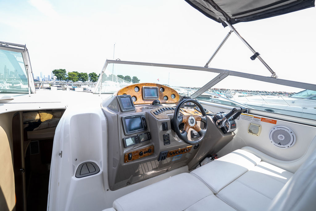 Yacht helm and bridge with wood trim and Chicago marina in background