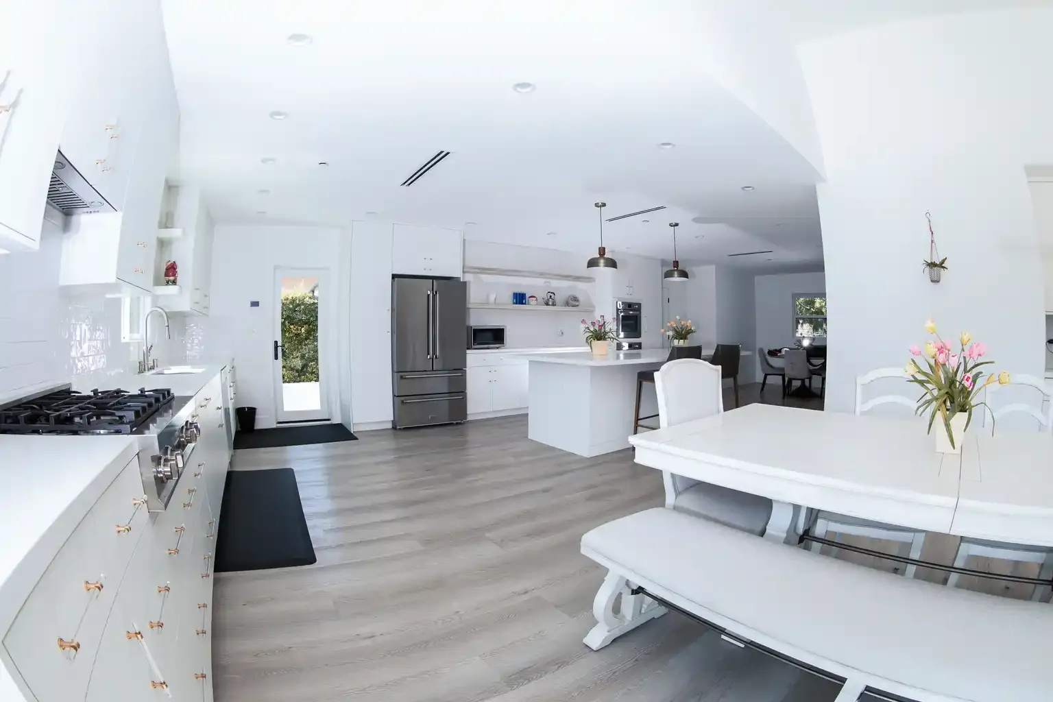 Modern chef's kitchen with white cabinetry and stainless steel appliances at men's sober living home Van Nuys CA — The Comeback SL
