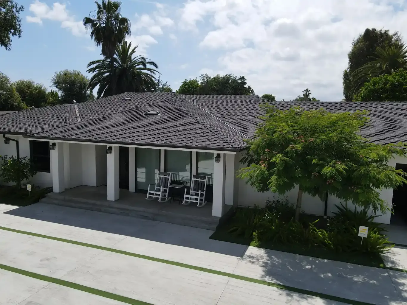 Front exterior and covered porch with rocking chairs at men's sober living home Van Nuys CA — The Comeback SL