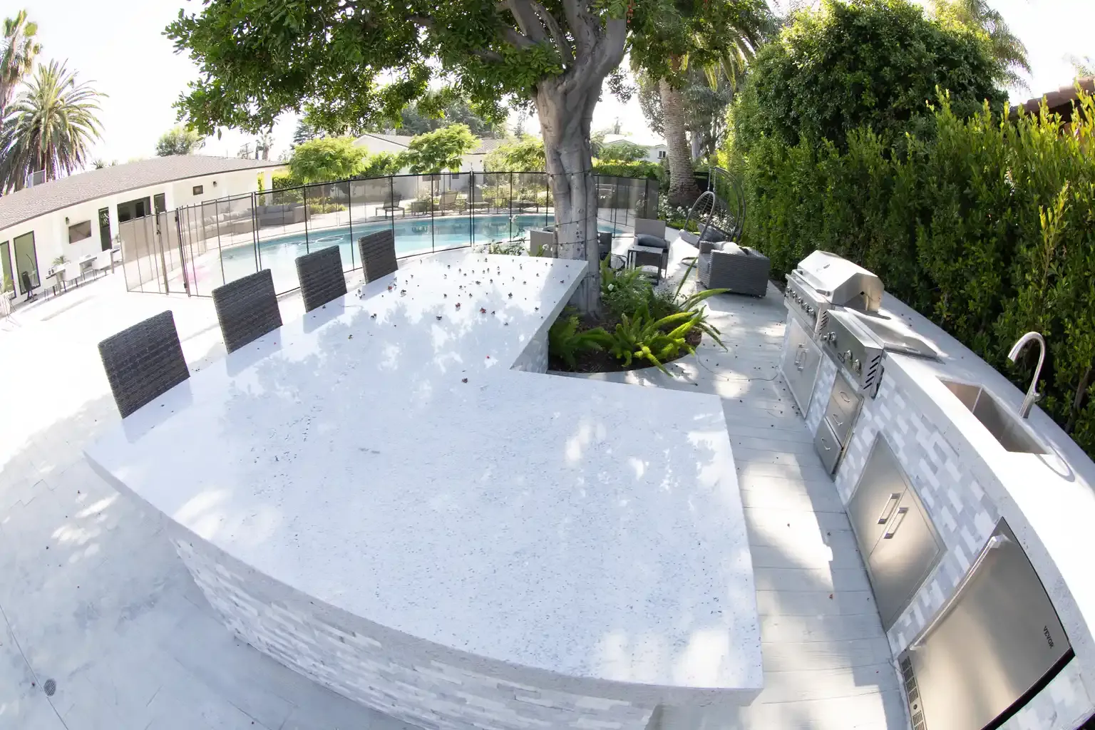 Outdoor BBQ and dining area with pool view at men's sober living home Van Nuys CA — The Comeback SL