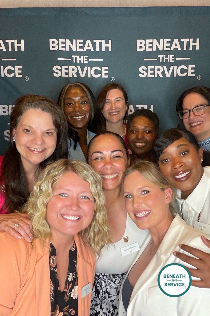 Cohort 9 graduates posing together at a Beneath the Service event