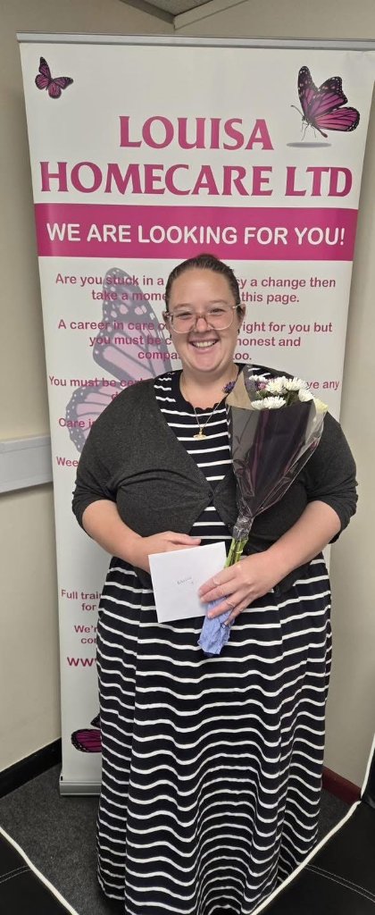 Team member with flowers and thank you card