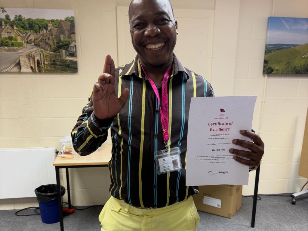 Malvern Jere holding certificate of excellence