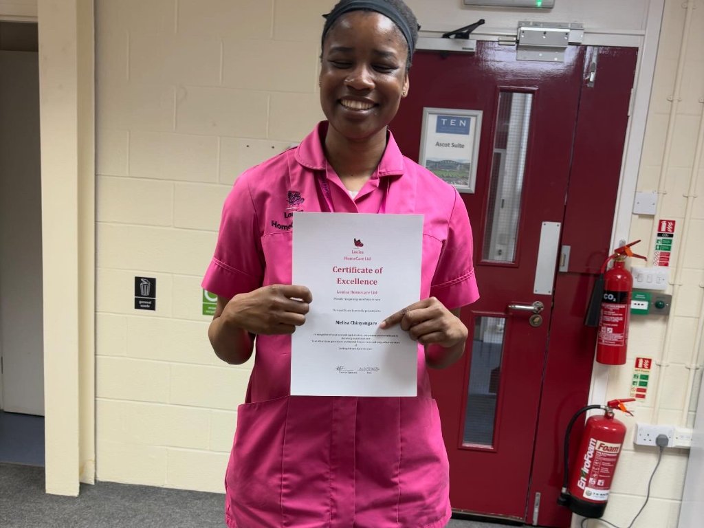 Melisa Chinyangaro holding certificate of excellence