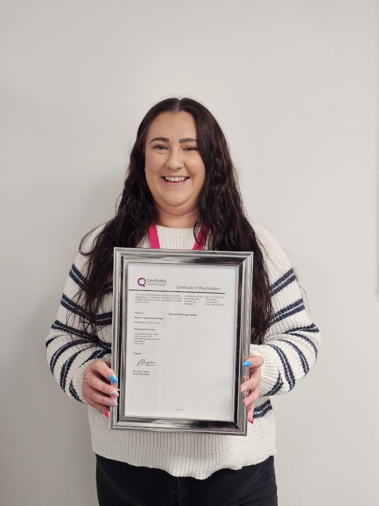 Keely holding registration certificate